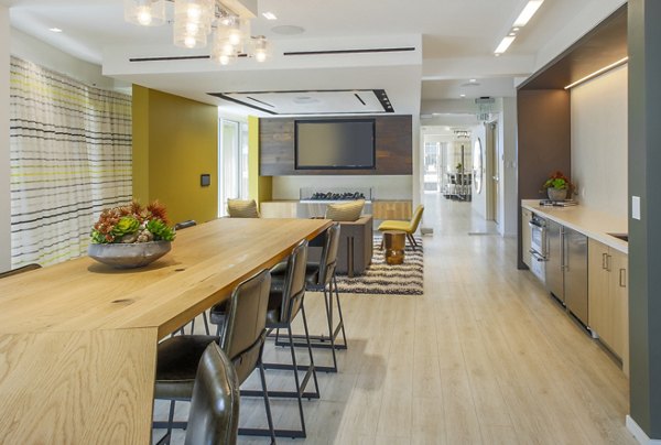 Stylish clubhouse with modern furnishings at mResidences Olympic & Olive Apartments, a Greystar luxury property
