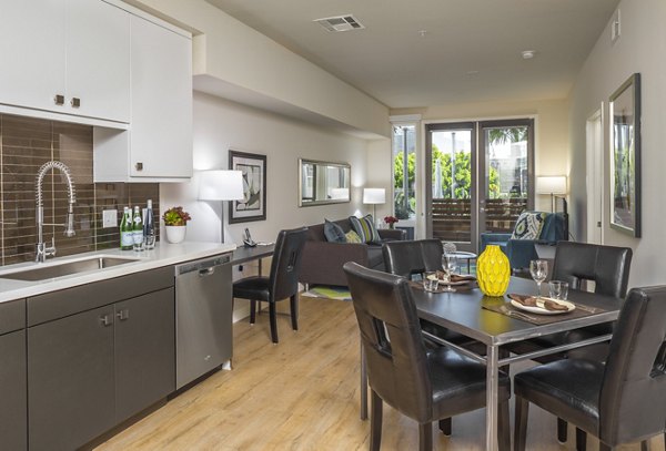 Dining area featuring modern decor at mResidences Olympic & Olive Apartments, showcasing luxury living in a stylish environment