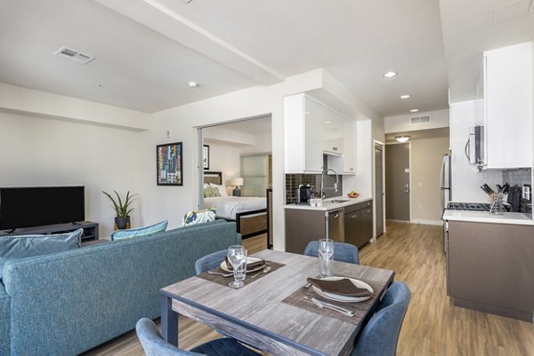 Dining area with modern decor and natural lighting at mResidences Olympic & Olive Apartments