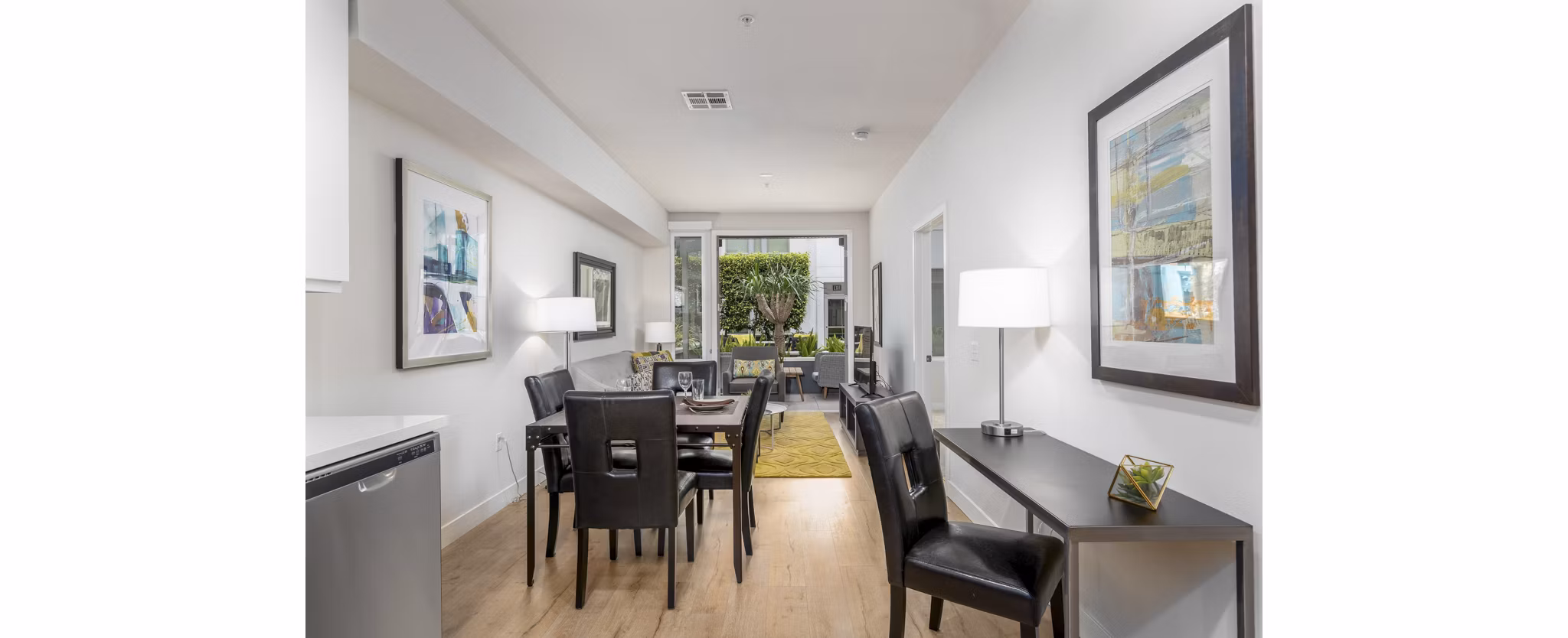 Dining area with modern decor at mResidences Olympic & Olive Apartments, featuring elegant lighting and stylish furniture
