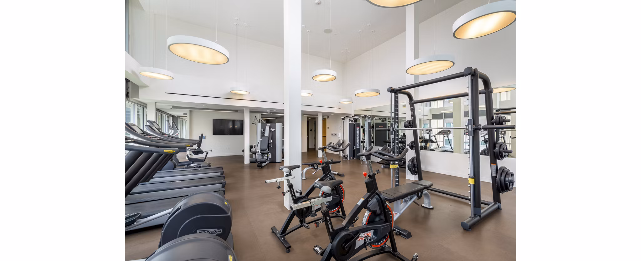 Fitness center featuring state-of-the-art equipment at mResidences Olympic & Olive Apartments