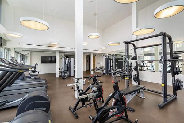 Fitness center featuring state-of-the-art equipment at mResidences Olympic & Olive Apartments