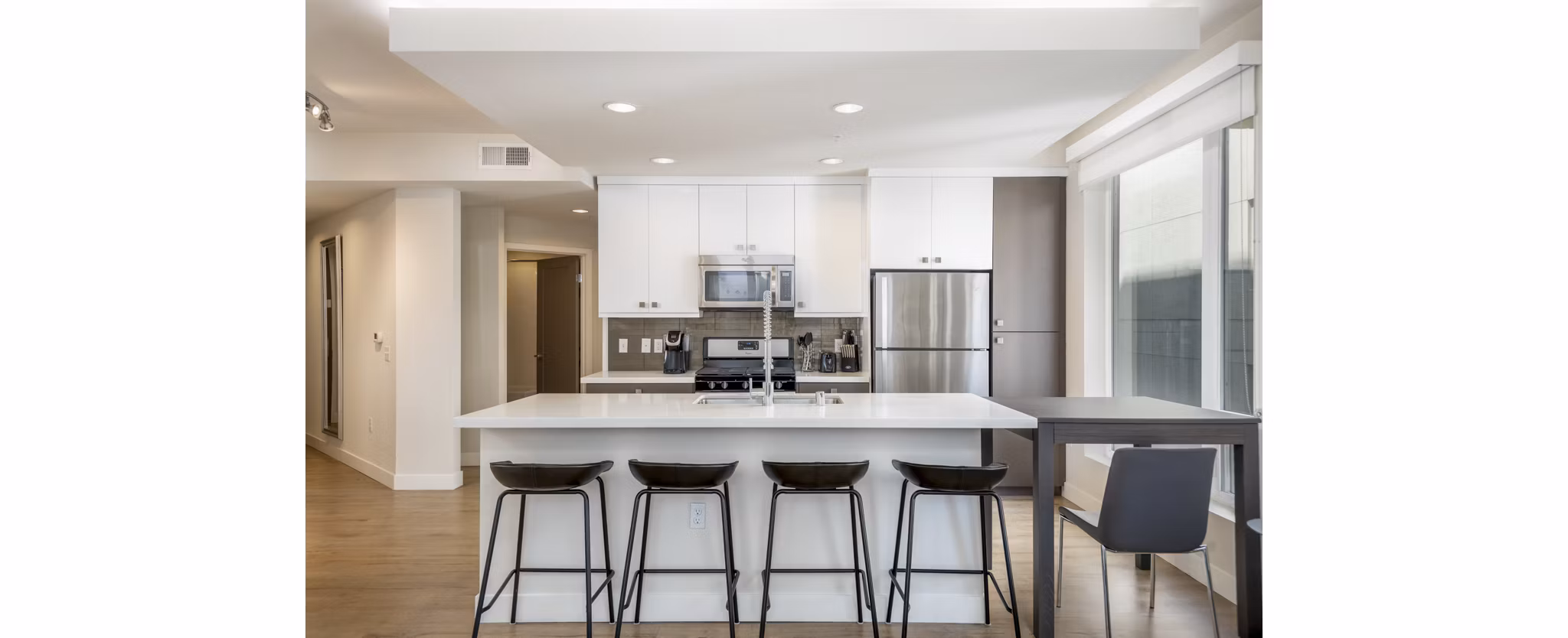 Spacious kitchen with sleek countertops and modern appliances at mResidences Olympic & Olive Apartments in Seattle