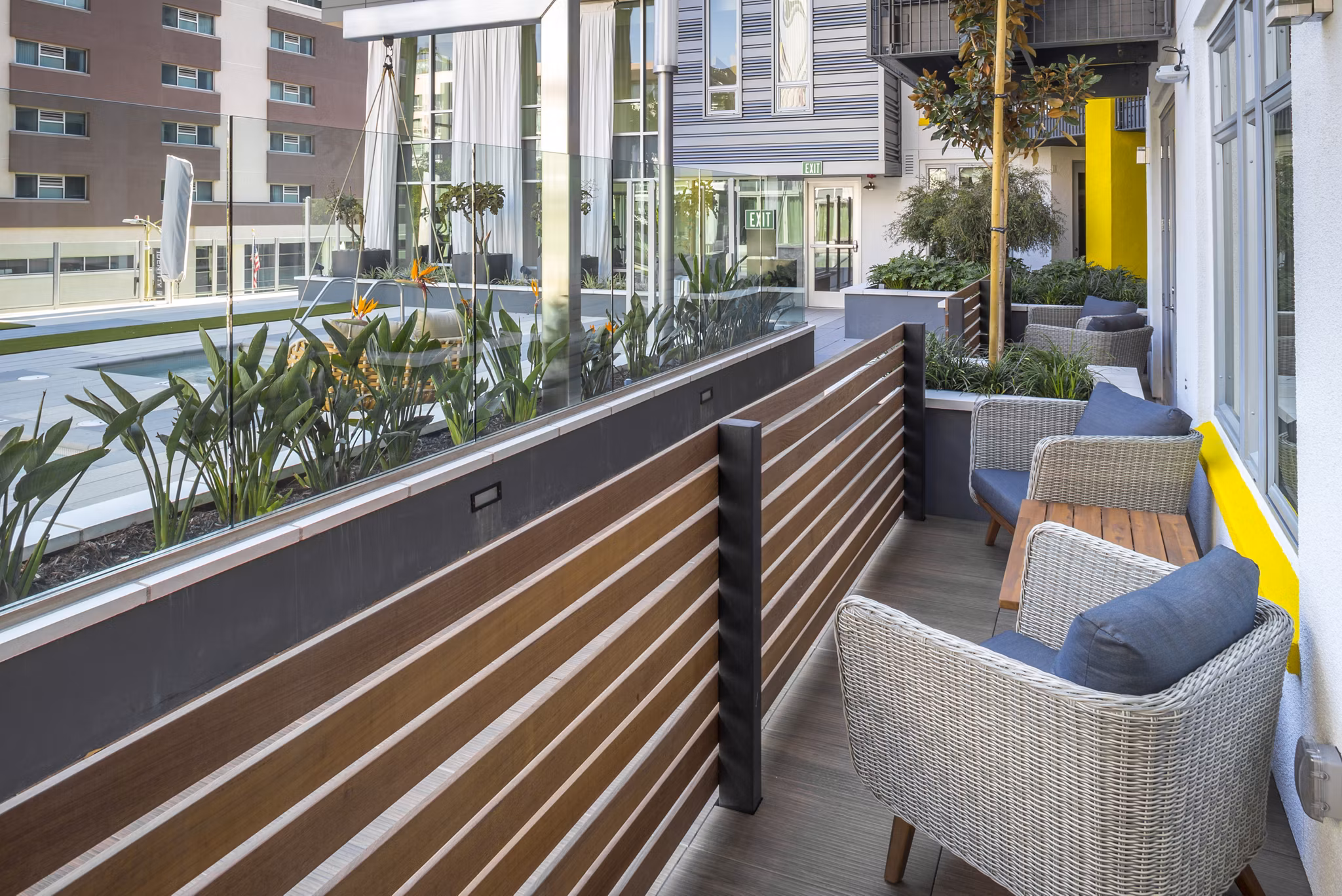 Modern outdoor patio with stylish seating at mResidences Olympic & Olive Apartments, perfect for relaxation and social gatherings