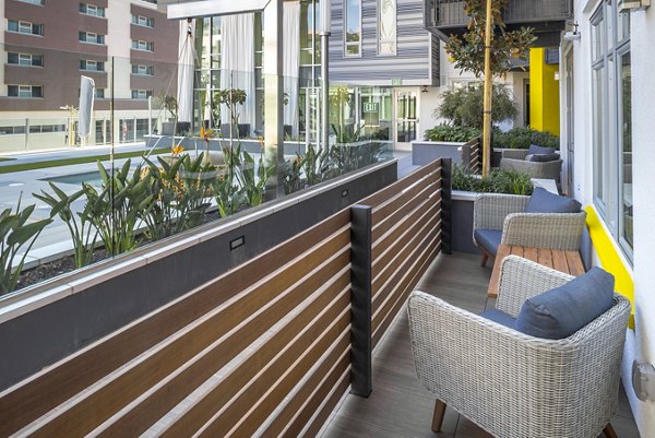 Modern outdoor patio with stylish seating at mResidences Olympic & Olive Apartments, perfect for relaxation and social gatherings