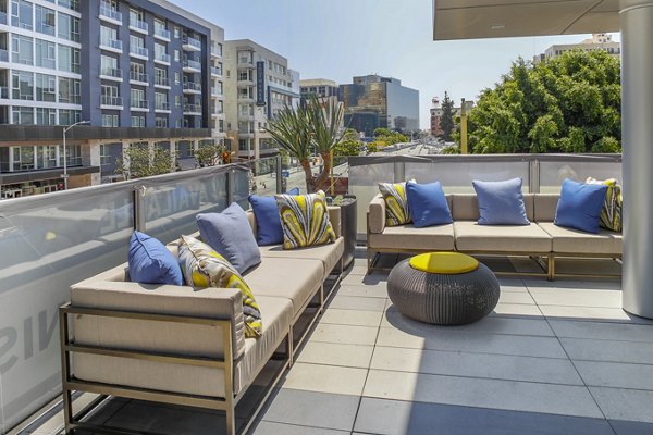 Rooftop deck at mResidences: Stylish outdoor seating and city views at Olympic & Olive Apartments