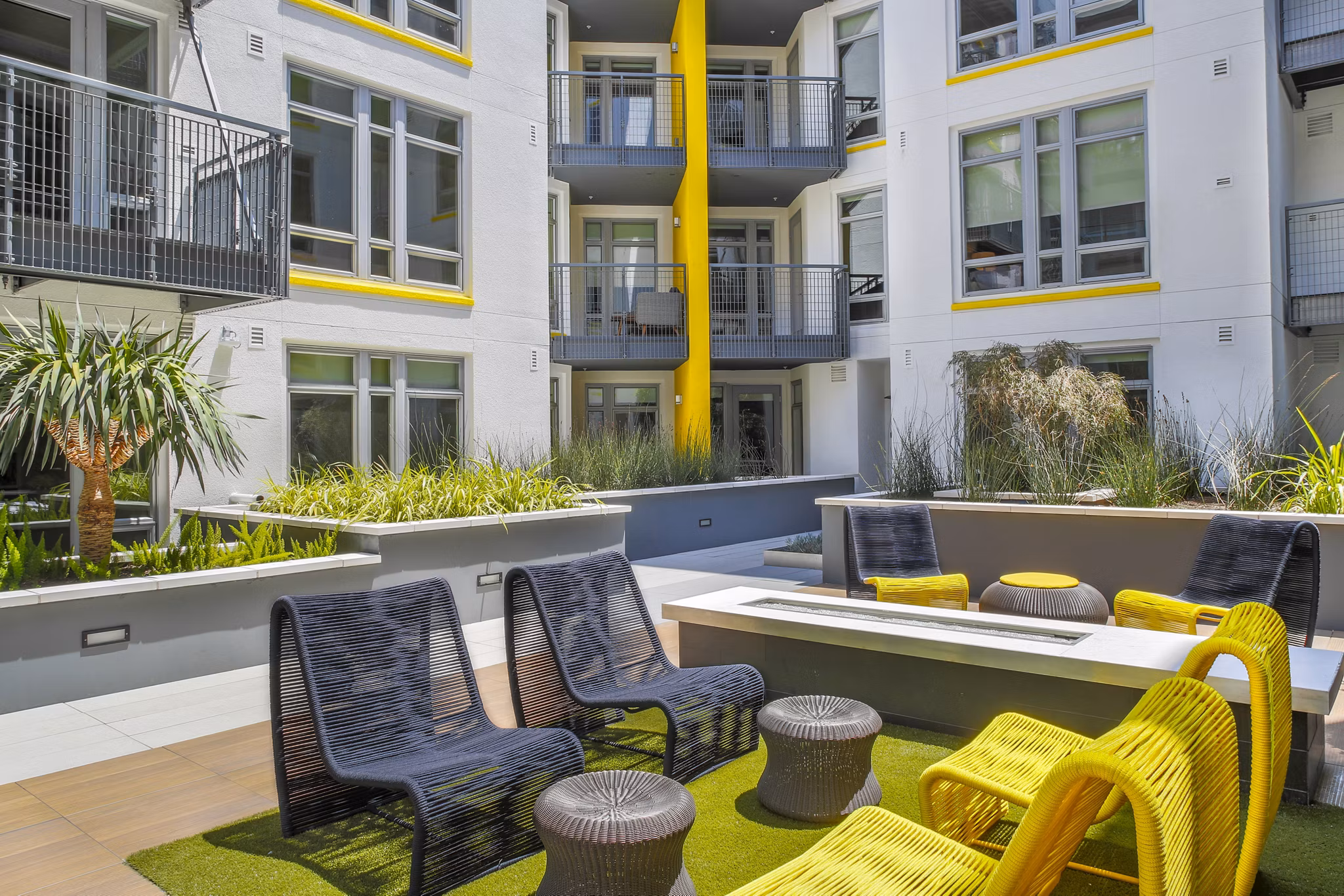 Fire pit with seating area at mResidences Olympic & Olive Apartments, a luxury community offering relaxation and socializing in Los Angeles