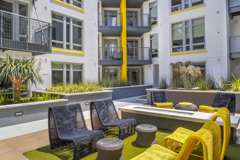 Fire pit with seating area at mResidences Olympic & Olive Apartments, a luxury community offering relaxation and socializing in Los Angeles