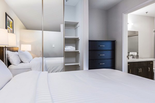 Spacious bedroom with modern furnishings in mResidences Silicon Valley Apartments