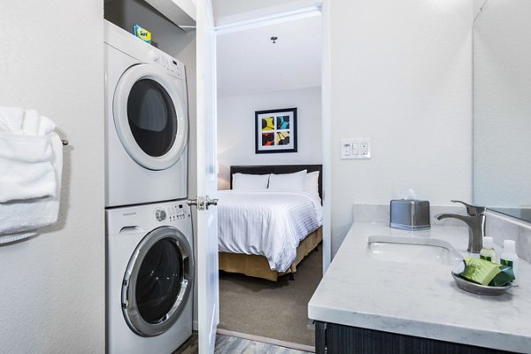 Bath and laundry room with modern fixtures at mResidences Silicon Valley Apartments