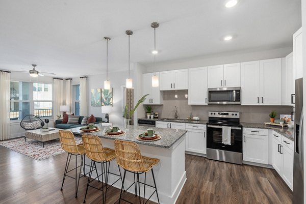 Modern kitchen with stainless steel appliances at Wentworth Park Apartments