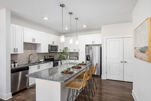 Modern kitchen with stainless steel appliances at Wentworth Park Apartments