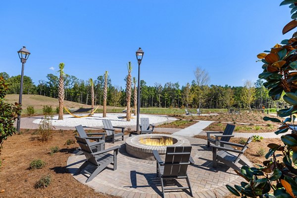 Fire pit with cozy seating area at Wentworth Park Apartments offering luxury outdoor relaxation space