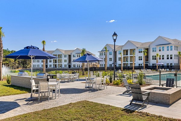 Courtyard featuring lush landscaping and seating areas at Wentworth Park Apartments