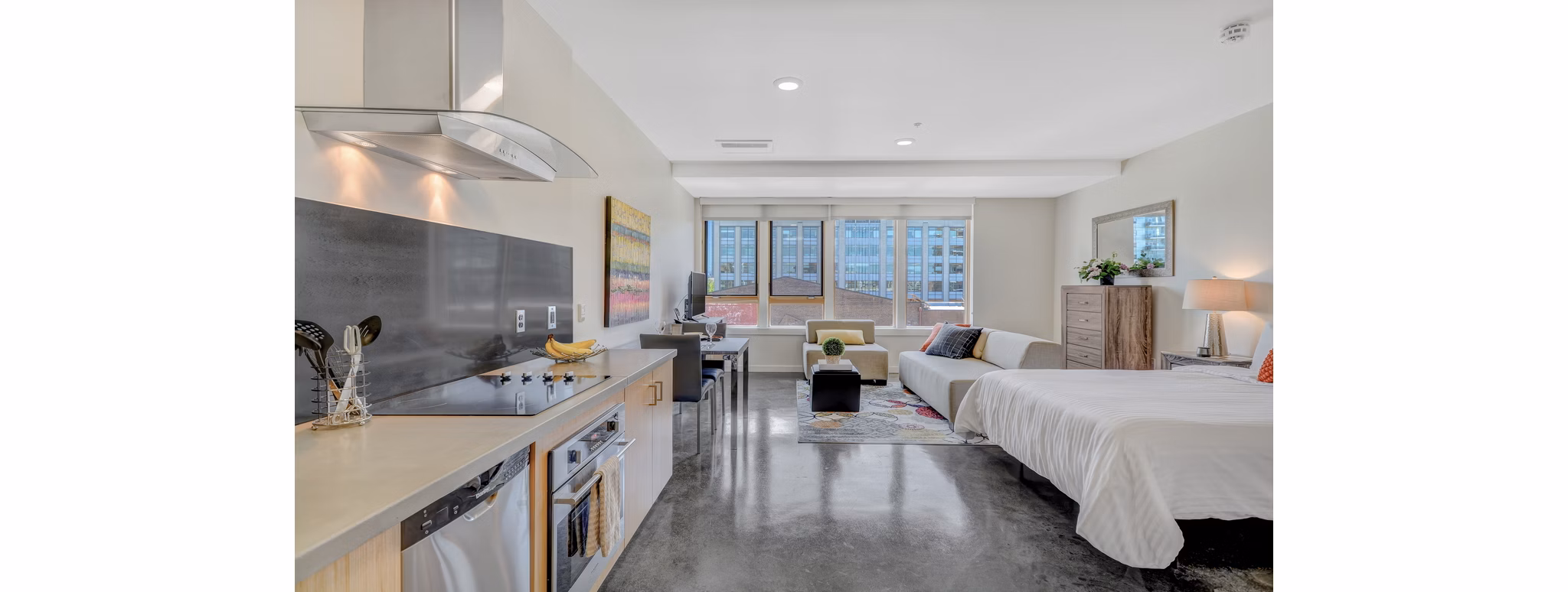 Luxurious kitchen with granite countertops and stainless steel appliances in mResidences Portland Pearl District Apartments