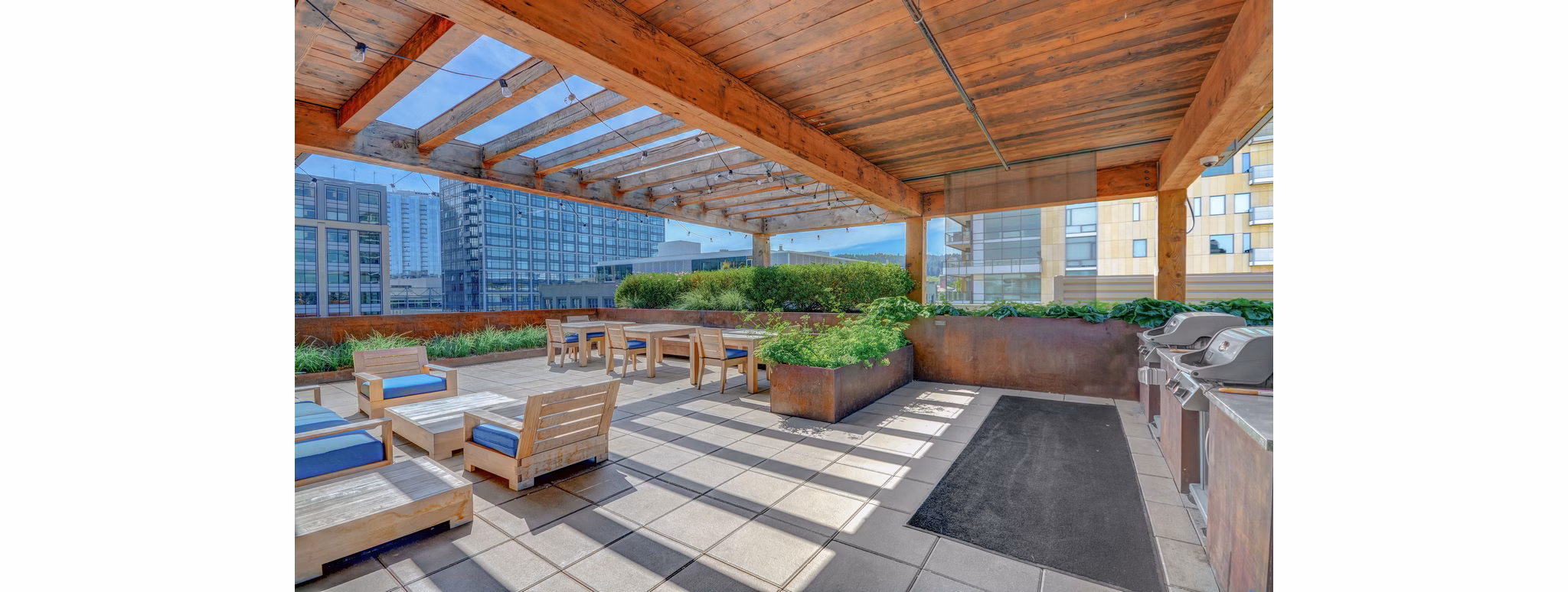Outdoor grilling area with modern furniture in mResidences Portland Pearl District Apartments
