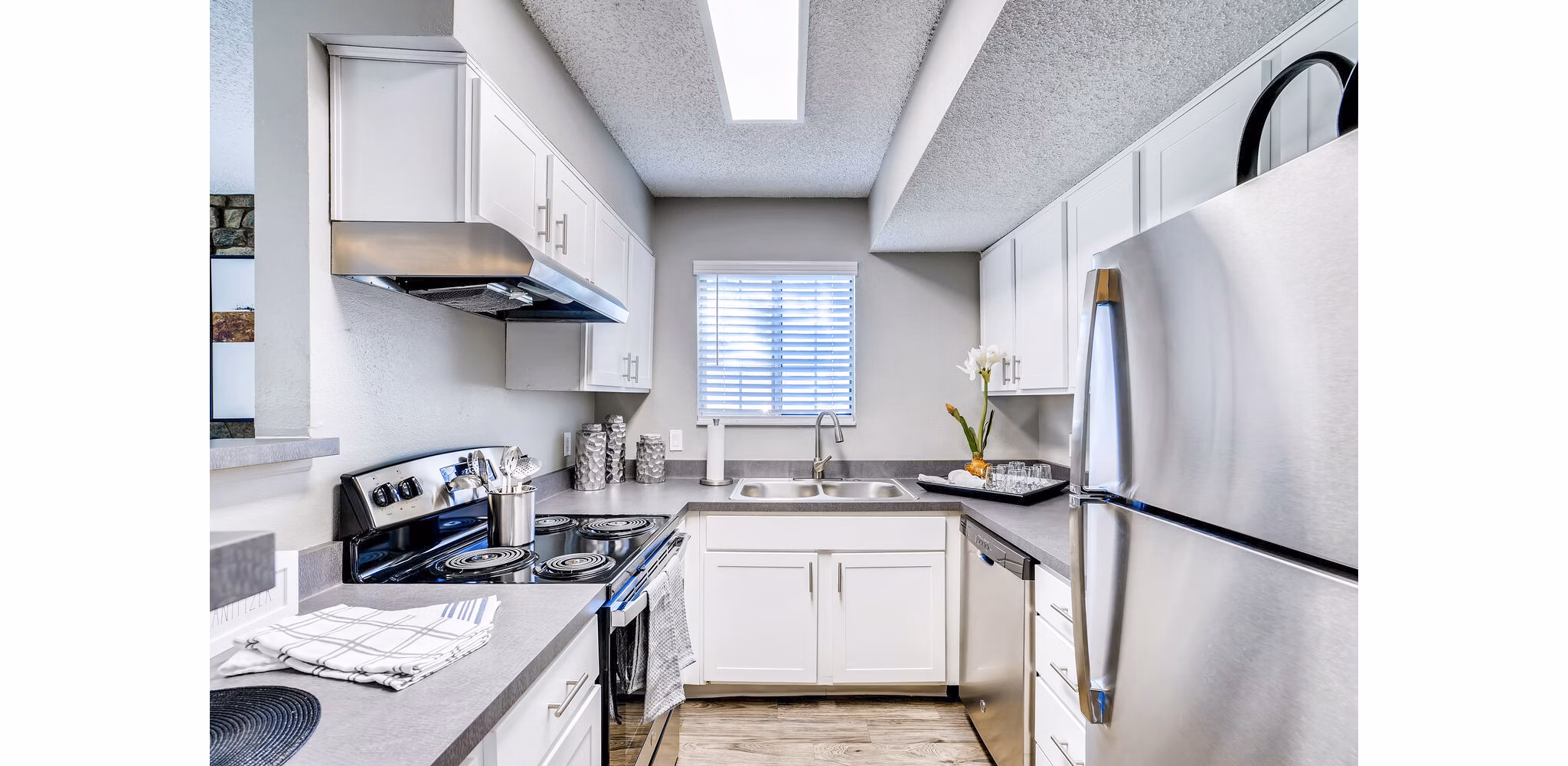 Modern kitchen with stainless steel appliances at Loretto Heights Apartments, luxurious living in a premier setting