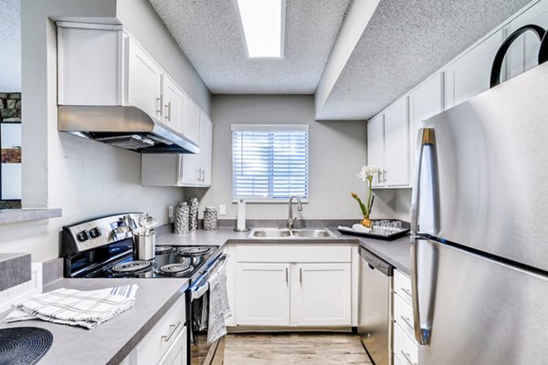 Modern kitchen with stainless steel appliances at Loretto Heights Apartments, luxurious living in a premier setting