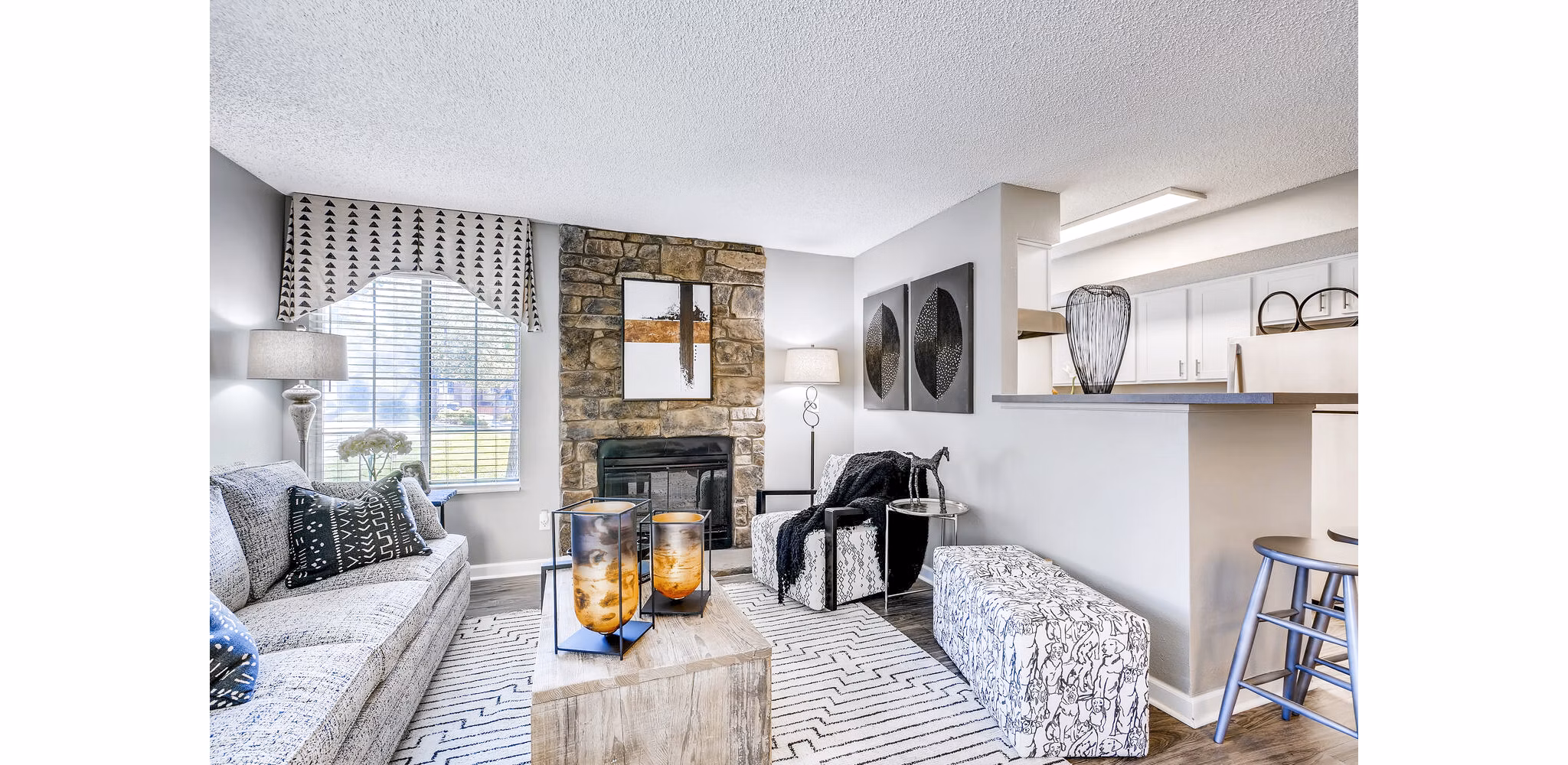 Spacious living room with modern decor and large windows at Loretto Heights Apartments, luxury rentals by Greystar