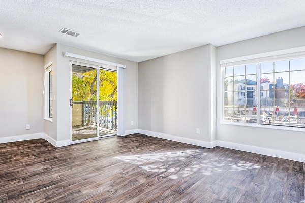 Inviting living room with modern decor and large windows at Loretto Heights Apartments