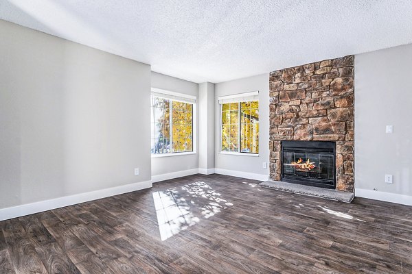 Spacious living room with modern decor and abundant natural light at Loretto Heights Apartments
