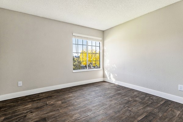 Spacious living room with modern furnishings and natural light in Loretto Heights Apartments