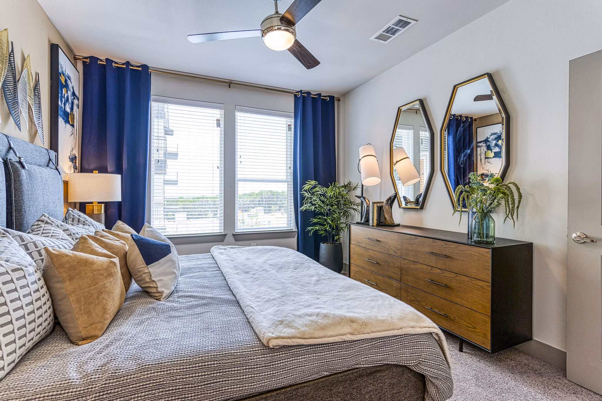 Cozy bedroom with modern decor in The Banks of Springdale Apartments, featuring comfortable furnishings and ample natural light