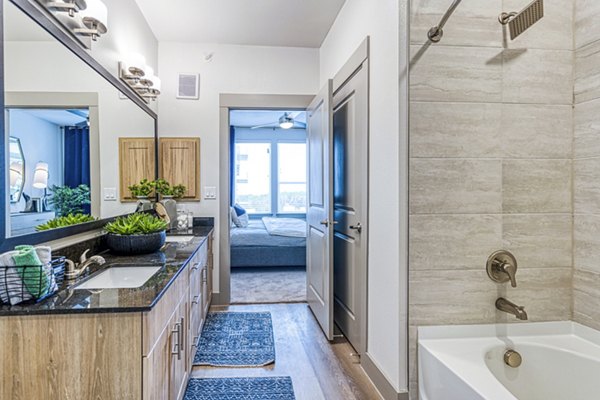 Elegant bathroom with marble countertops at The Banks of Springdale Apartments