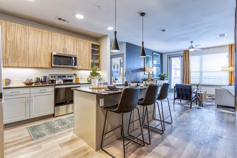 Modern kitchen with stainless steel appliances at The Banks of Springdale Apartments