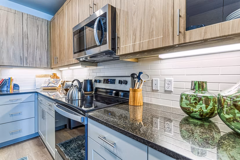 Modern kitchen with stainless steel appliances at The Banks of Springdale Apartments Ideal Greystar luxury living with practical elegance