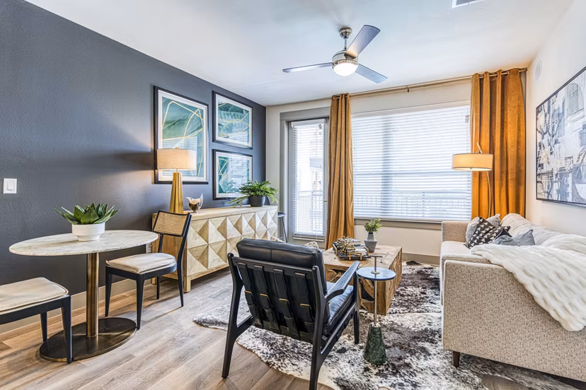Spacious living room with modern decor at The Banks of Springdale Apartments, a luxury Greystar community