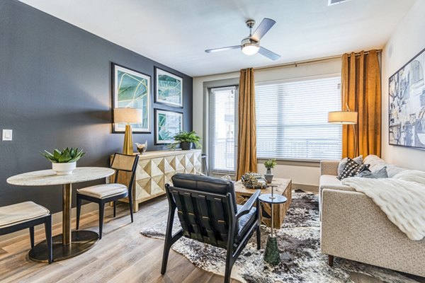 Spacious living room with modern decor at The Banks of Springdale Apartments, a luxury Greystar community