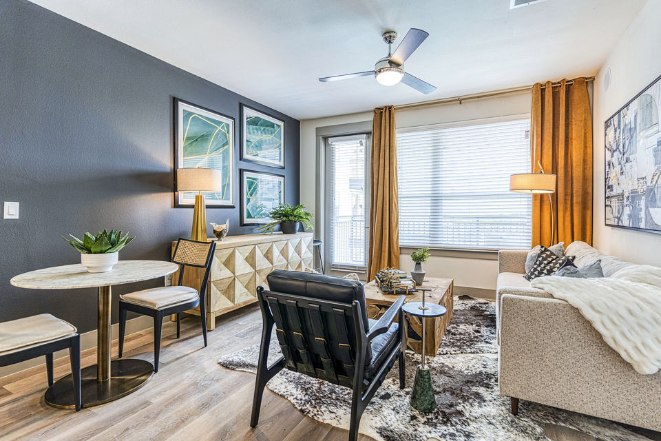 Spacious living room with modern decor at The Banks of Springdale Apartments, a luxury Greystar community