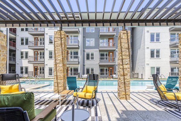 Pool patio offering luxury relaxation at The Banks of Springdale Apartments Enjoy stylish seating and serene atmosphere at this premier Greystar community