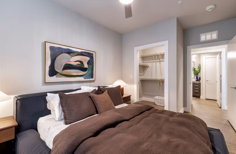 Spacious bedroom with modern furnishings at Urban East Apartments