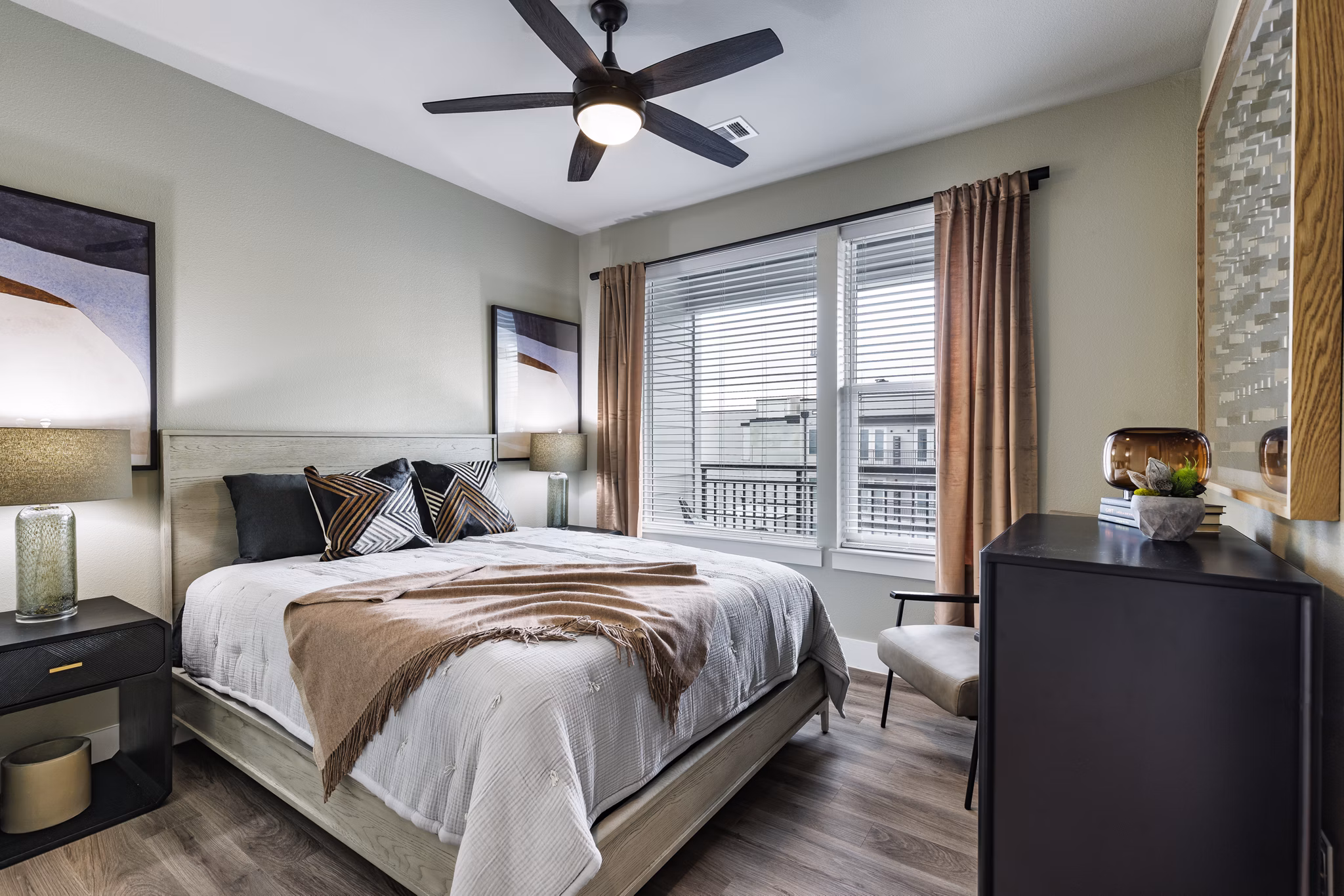 Spacious bedroom with modern furnishings at Urban East Apartments
