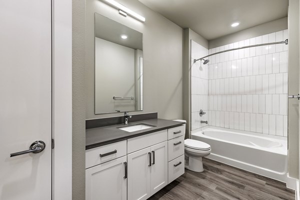 Modern bathroom featuring sleek fixtures and marble countertops in Urban East Apartments