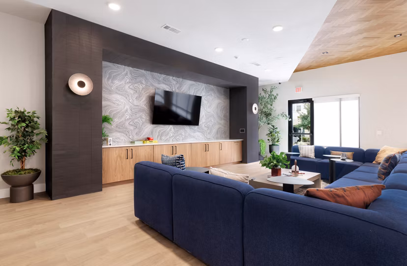 Clubhouse game room with pool table and lounge seating at Urban East Apartments' luxury residence