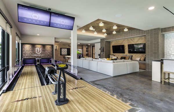 Clubhouse game room with pool table and lounge seating at Urban East Apartments' luxury residence