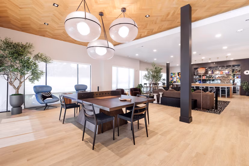 Modern clubhouse with communal seating and entertainment areas at Urban East Apartments