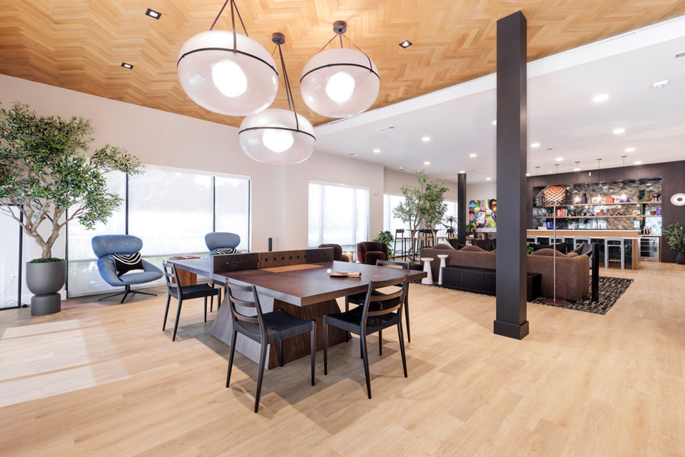 Modern clubhouse with communal seating and entertainment areas at Urban East Apartments