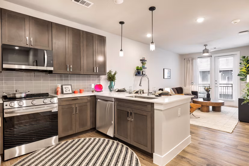 Modern kitchen featuring stainless steel appliances at Urban East Apartments