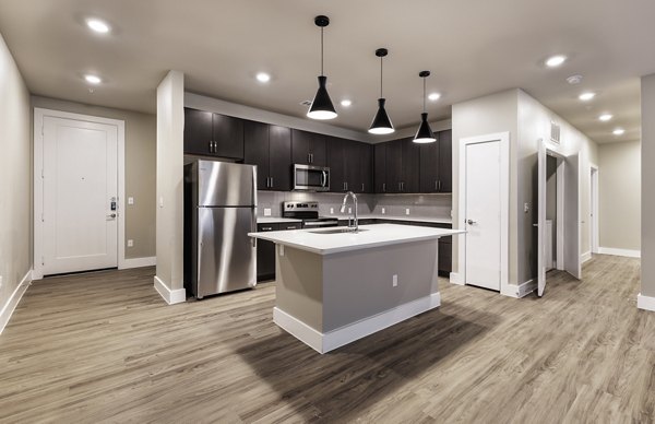 Modern kitchen featuring stainless steel appliances at Urban East Apartments