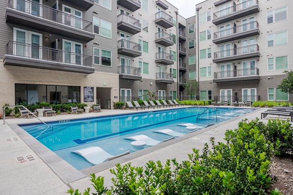 Inviting outdoor pool at Urban East Apartments offering relaxation and leisure in a serene setting