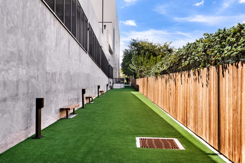 Lush courtyard with seating and gardens at Urban East Apartments offering a tranquil escape