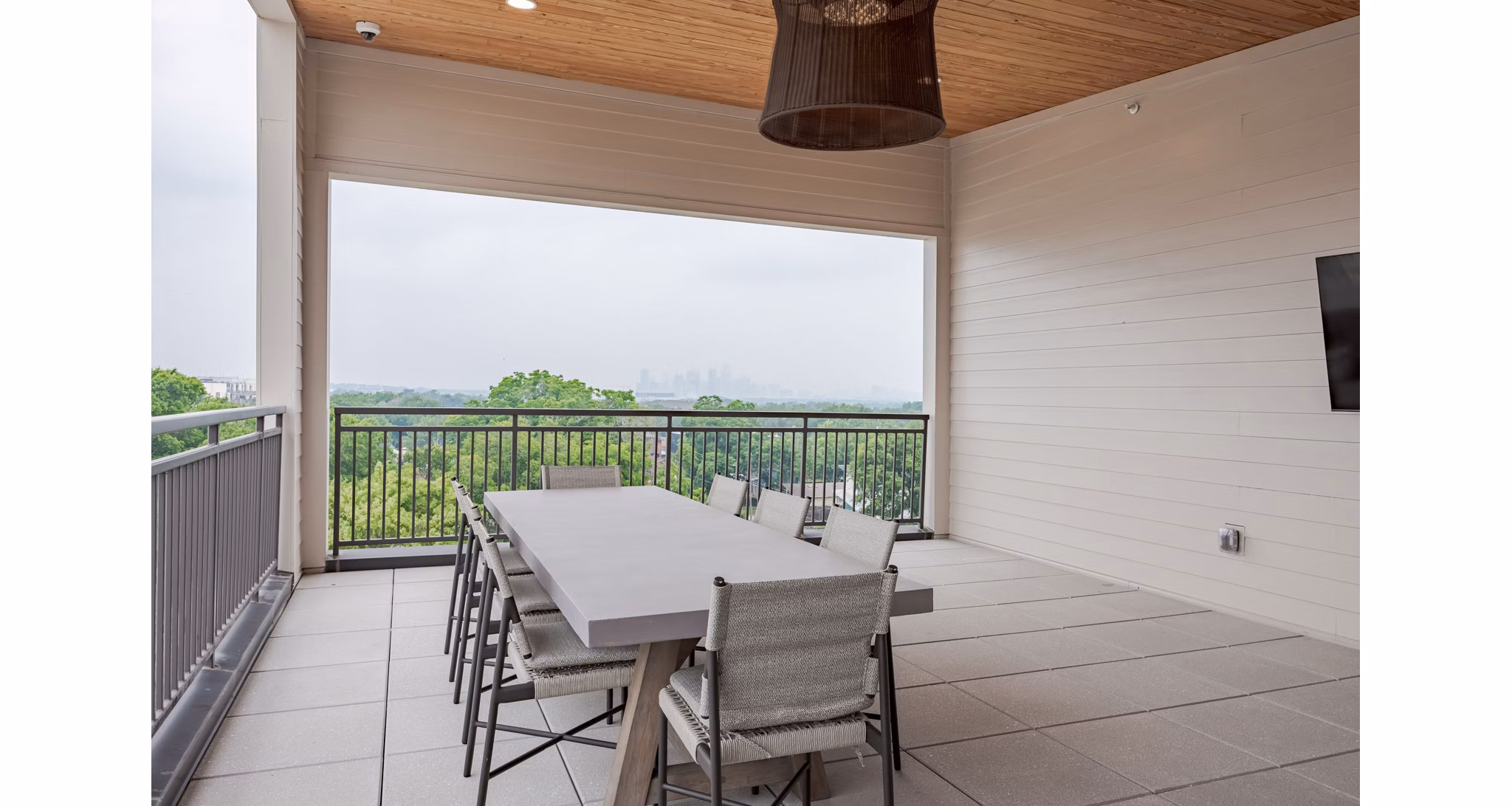 Courtyard at Urban East Apartments: Lush greenery and modern seating area in luxury apartments complex