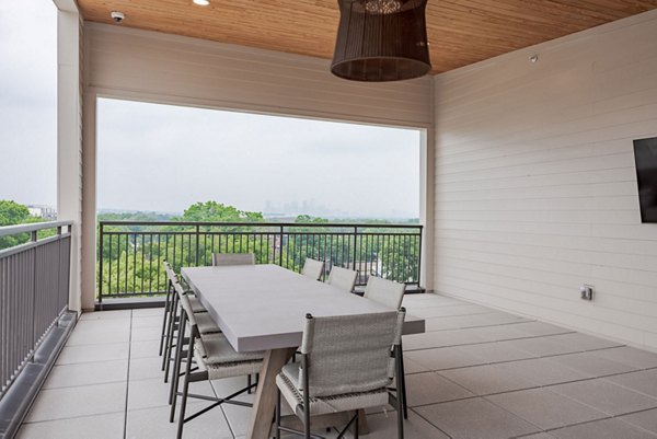 Courtyard at Urban East Apartments: Lush greenery and modern seating area in luxury apartments complex