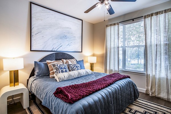 Bedroom featuring cozy ambience and modern furnishings at West End Apartments, a luxury living space
