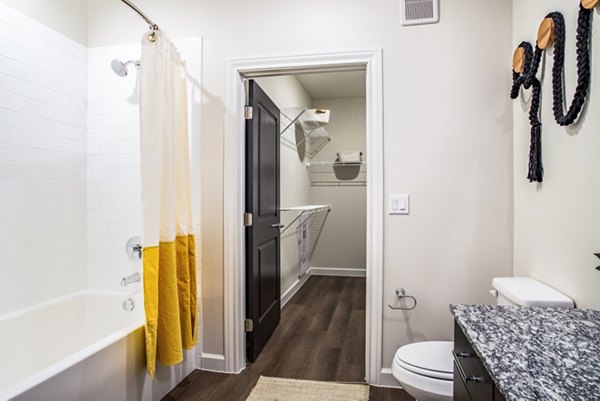Bathroom featuring elegant fixtures and marble countertops in West End Apartments