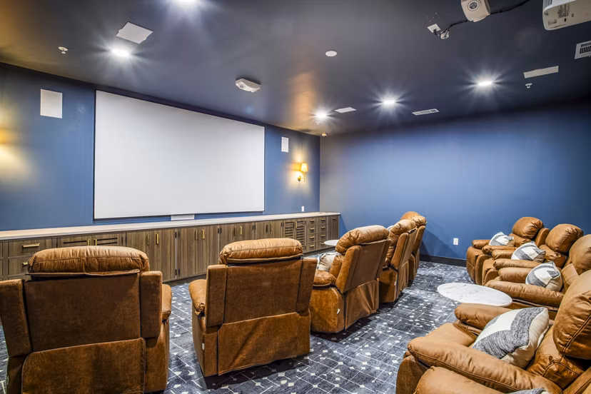 Clubhouse theater with plush seating at West End Apartments, luxury living by Greystar